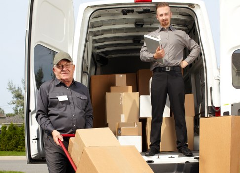 Professional movers packing belongings in Merton Storage.