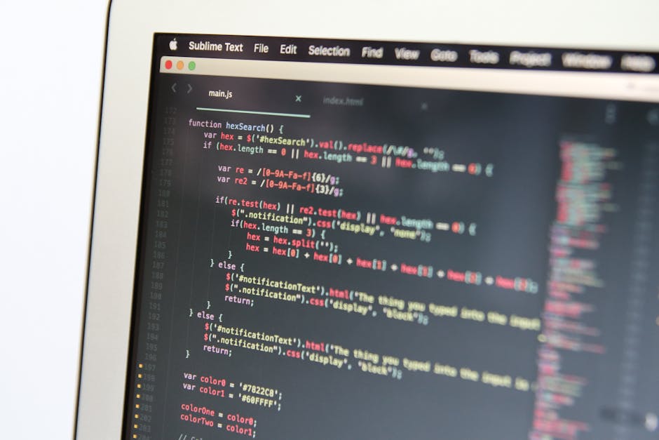 Close-up view of a computer screen displaying a webpage's HTML code with multi-colored text in pink, green, and yellow. The code includes various tags such as `<ul>`, `<li>`, `<a>`, `<class>`, and `<h